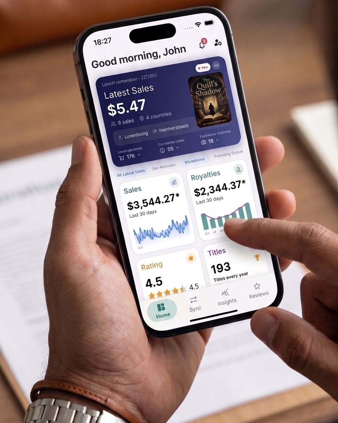 TrackingInk book sales and royalty dashboard displayed on an iPhone.